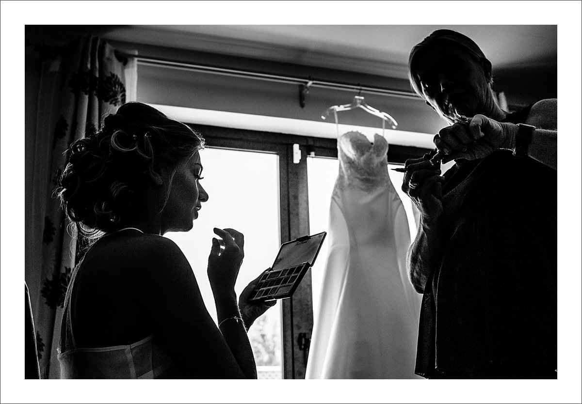 a silhouette photo of a bride having her makeup done in Marbella