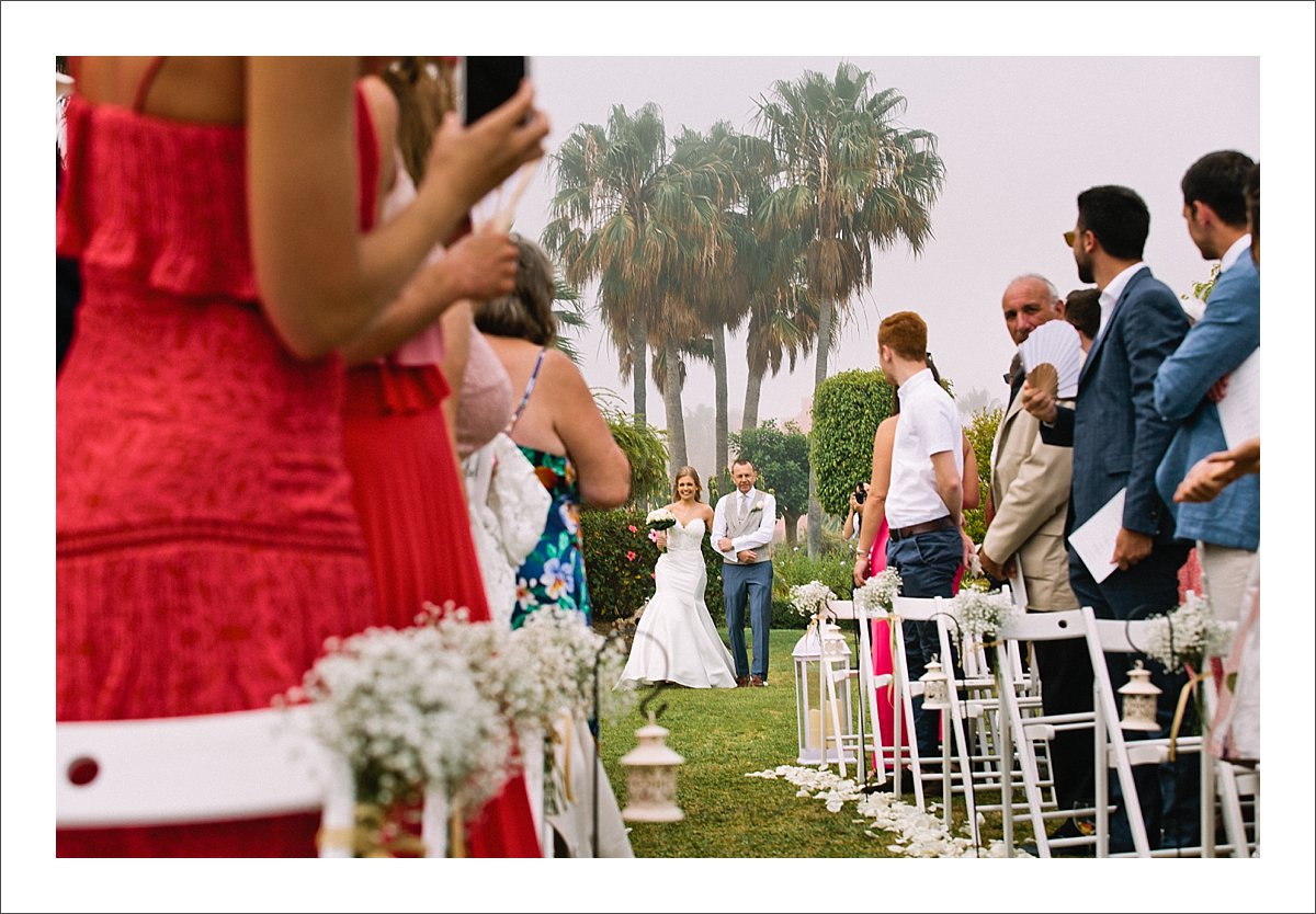 bride and father of the bride walking down the isle